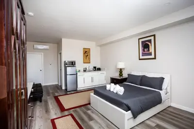 a bedroom with a bed and a kitchen at Centrally Located Cozy Studio Apartment in SD in San Diego