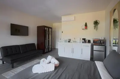 a living room with a couch and a kitchen at Awesome Balboa and Downtown View with Cozy Patio in San Diego