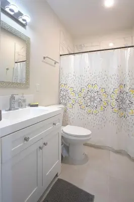 a bathroom with a toilet and a shower curtain at Awesome Balboa and Downtown View with Cozy Patio in San Diego