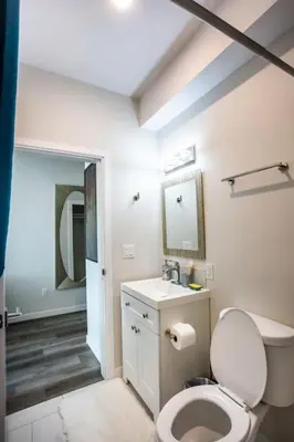 a bathroom with a toilet and a sink and a mirror at Lovely Studio w Full Kitchen in Heart of San Diego in San Diego