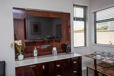 a living room with a television on a wall at 2 Bedroom, 2 Bathroom Detached Apt Max 7 Sleepers in San Diego