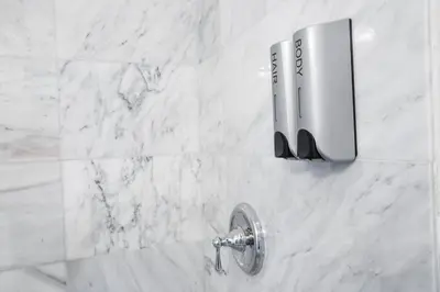 a bathroom sink with a faucet on a marble wall at 2 Bedroom, 2 Bathroom Detached Apt Max 7 Sleepers in San Diego