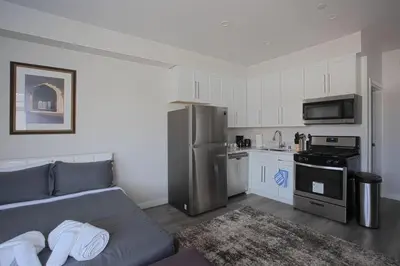 a living room with a couch and a kitchen at 2 Bedroom, 2 Bathroom Detached Apt Max 7 Sleepers in San Diego