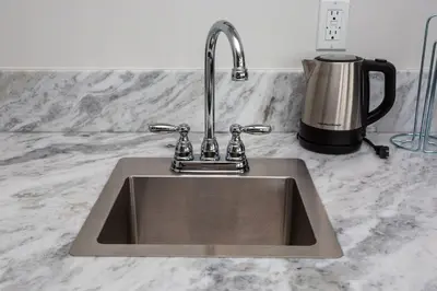 a kitchen sink with a faucet on a counter at One Bedroom Apartment with San Diego Downtown View in San Diego