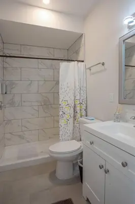 a white bathroom with a toilet and a sink at One Bedroom Apartment with San Diego Downtown View in San Diego