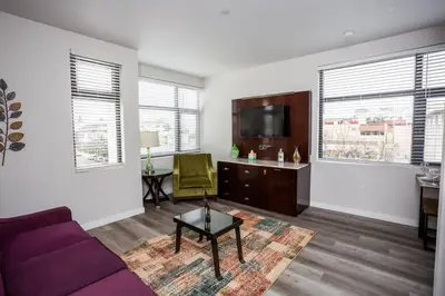 a living room with a purple couch and a tv at Prime Location - Awesome View -1 bedroom Apartment in San Diego