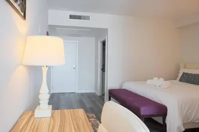 a bedroom with a bed and a table with a lamp at Spacious 1 Bedroom Apartment in Balboa Park in San Diego