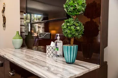 a counter with vases and a bottle on it at Spacious 500 sqft Studio with Balboa Park View in San Diego