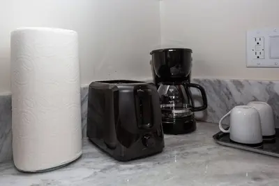 a counter with a coffee maker and a roll of paper towels at 1 Bedroom Apartment with Luxurious Design in SD in San Diego