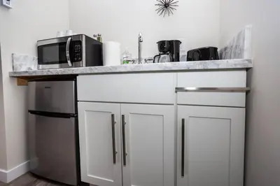 a kitchen with a counter with a microwave and a refrigerator at Studio with Large Balcony- San Diego Gateway in San Diego