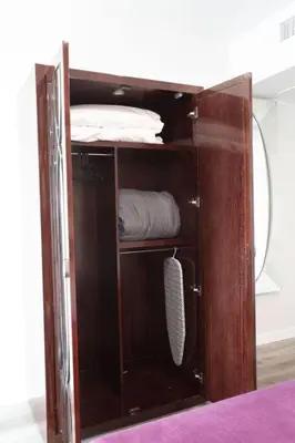 a wooden cabinet with a mirror in a room at The Most Beautiful Bay View from 1 Bedroom Apt in San Diego