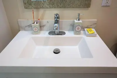 a bathroom sink with two toothbrushes and a faucet at The Most Beautiful Bay View from 1 Bedroom Apt in San Diego