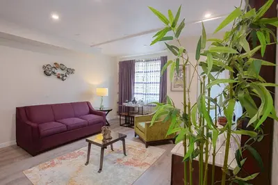 a living room with a purple couch and a table at Luxurious One Bedroom Suite with Balboa Park View in San Diego