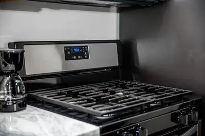 a stove top oven sitting on top of a counter at Luxurious One Bedroom Suite with Balboa Park View in San Diego