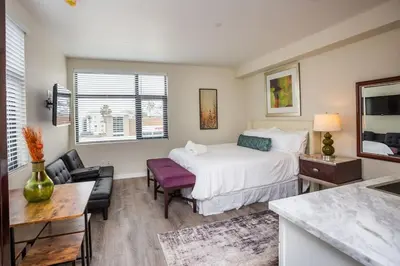 a bedroom with a bed and a table and chairs at Next to San Diego Downtown - Cali King Size Studio in San Diego