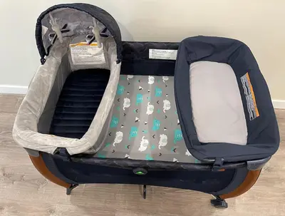 an open suitcase with a baby crib with animals on it at Next to San Diego Downtown - Cali King Size Studio in San Diego