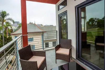 two chairs on a balcony with a view of the city at Studio with Beautiful View next to Downtown in San Diego