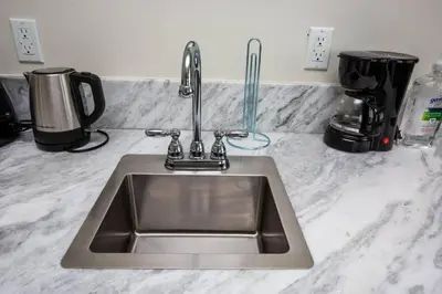 a kitchen counter with a sink and a coffee maker at Modern, Luxurious and Prime location All in One in San Diego