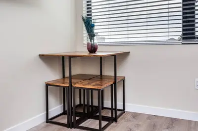 a table with a vase on it next to a window at Modern, Luxurious and Prime location All in One in San Diego