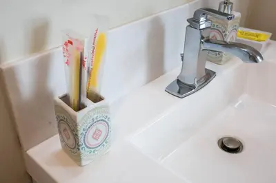 a bathroom sink with a toothbrush holder on it at Modern, Luxurious and Prime location All in One in San Diego