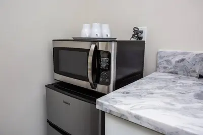 a microwave oven sitting on top of a counter at Modern, Luxurious and Prime location All in One in San Diego
