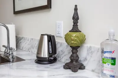 a kitchen counter with a coffee maker and a bottle of water at Premier Location with Great Scenic Downtown View in San Diego