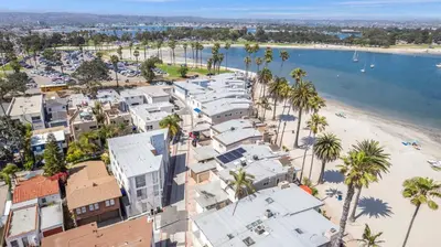an aerial view of a beach with houses and palm trees at Highly rated Best Beach! AC Luxury KING Beds! in San Diego