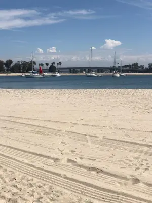a sandy beach with boats in the water at Highly rated Best Beach! AC Luxury KING Beds! in San Diego