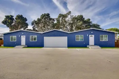 a blue house with a white garage at Modern Duplex Near Gaylord Resort and Bayfront! in Chula Vista