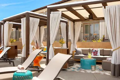 an outdoor patio with chairs and a pergola at Kona Kai Resort & Spa, a Noble House Resort in San Diego