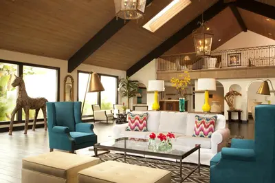 a living room with a white couch and blue chairs at Kona Kai Resort & Spa, a Noble House Resort in San Diego
