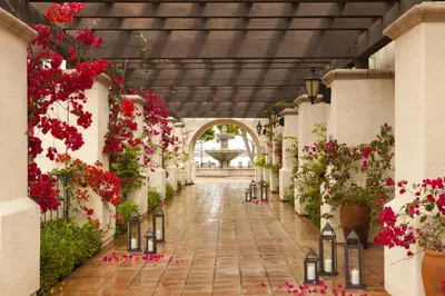 a corridor of a building with flowers and plants at Kona Kai Resort & Spa, a Noble House Resort in San Diego