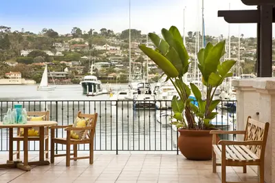 a balcony with a table and chairs and a harbor at Kona Kai Resort & Spa, a Noble House Resort in San Diego