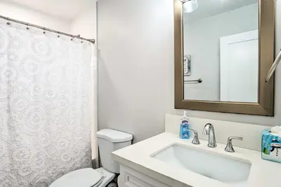 a bathroom with a sink and a toilet and a mirror at San Marcos Home with Patio and Grill - Walk to Lake! in San Marcos