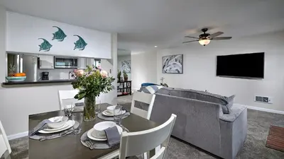 a living room with a table and a couch at New Listing Ocean and Harbor View Cottage in Beach Resort in Oceanside