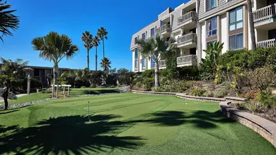 a golf course in front of a apartment building at New Listing Ocean and Harbor View Cottage in Beach Resort in Oceanside