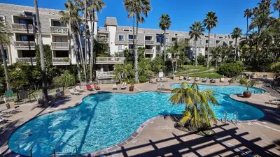 an overhead view of a swimming pool in a resort at New Listing Ocean and Harbor View Cottage in Beach Resort in Oceanside