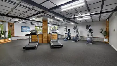 a gym with treadmills and ellipticals in a room at New Listing Ocean and Harbor View Cottage in Beach Resort in Oceanside