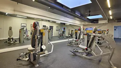 a gym with several tread machines in a room at New Listing Ocean and Harbor View Cottage in Beach Resort in Oceanside