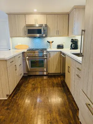 a kitchen with stainless steel appliances and wooden cabinets at California Getaway in San Clemente