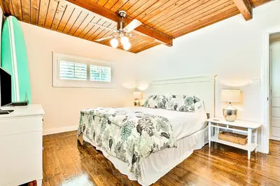 a bedroom with a bed and a ceiling fan at California Getaway in San Clemente
