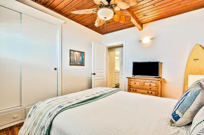 a bedroom with a bed and a ceiling fan at California Getaway in San Clemente