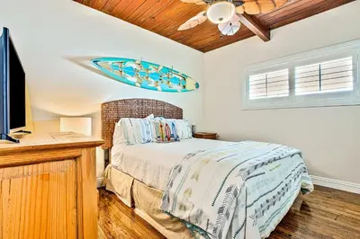 a bedroom with a bed and a flat screen tv at California Getaway in San Clemente