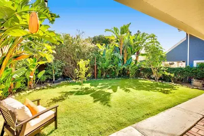 a garden with a bench and a grass yard at California Getaway in San Clemente
