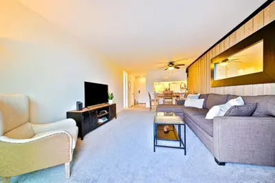 a living room with a couch and a tv at Pier View Retreat in Oceanside