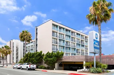 a hotel with cars parked in front of it at Best Western Yacht Harbor Hotel in San Diego