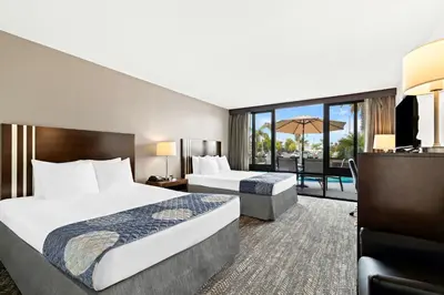 a hotel room with two beds and a balcony at Best Western Yacht Harbor Hotel in San Diego