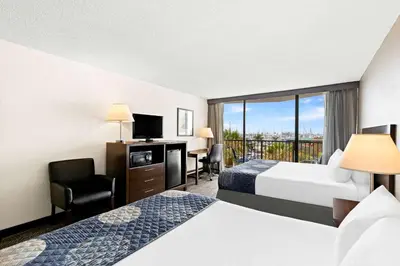 a hotel room with two beds and a balcony at Best Western Yacht Harbor Hotel in San Diego