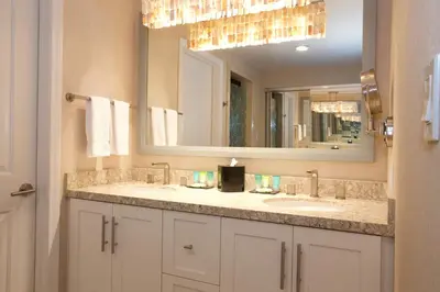 a bathroom with two sinks and a large mirror at Inn by the Sea, La Jolla in San Diego