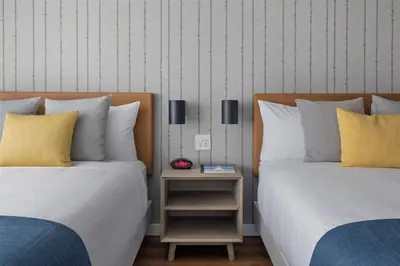 two beds sitting next to each other in a room at Sea Harbor Hotel - San Diego in San Diego